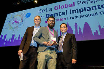 Aneel Jabbar accepting his poster award, with moderator Peter Fairbairn and speaker Hom-Lay Wang
